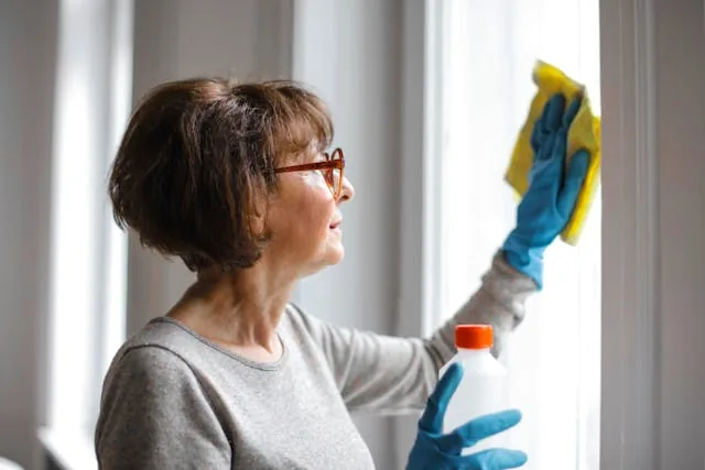 A girl cleaning a glass window